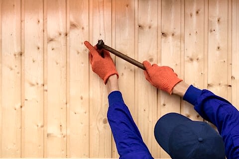 Contractor worker is holding a hammer